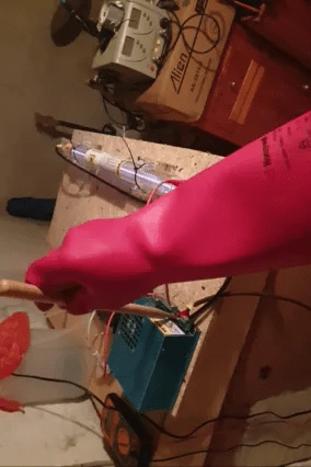 First time turning on the CO2 laser with insulating gloves, ensuring safety during DIY biohacking and implant sealing experiments.