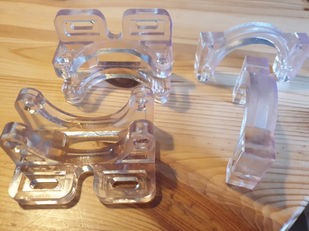 3D-printed resin holders designed for CO2 laser, used in DIY biohacking projects for precision and stability during implant sealing