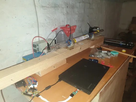Fully assembled CO2 laser setup on a table, with Arduino-controlled lathe and stepper driver for precise biohacking and implant sealing.