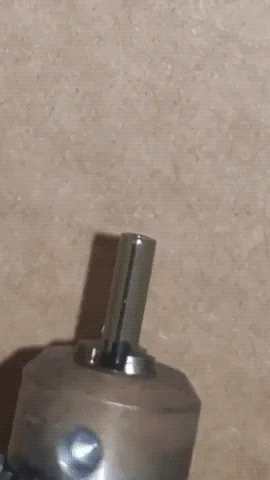 Lathe turning and sealing a DIY implant with a tritium rod, demonstrating the precision and technique used in biohacking projects for implant modification and tritium sealing.